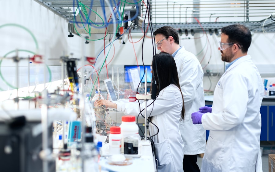 Two researchers at work among instruments in a laboratory.